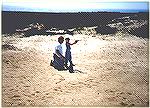 A father letting his young son shoot a .22 pistol for the first time.  Beautiful day, bright sun, Pacific Ocean in the background...of this memories are made.


photo by K.Foster, (c)1989 all right