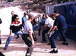 Dave Kotser instructs a class in Israel on the basics of the Israeli version of the Isosceles stance.  Dave is in the center foreground.  Apparently he is working on the basics of leg placement and fl