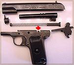 Norinco 9mm M-213 Tokarev pistol, field stripped. The red arrow points to the magazine well spacer.
