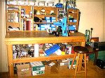 This is a picture of Bob Rowe's reloading bench, showing the stuff under the bench and the presses.  Unfortunately, I was just learning how to operate my new digital camera, so it's pretty blurry.