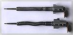 Side-by-side photo of Remington 700 firing pin assemblies.  The upper unit is the old style.  The lower unit is the new style with the bolt lock.
