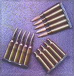6.5x55mm Swedish military ammunition on stripper clips.  Bottom left is cupro-nickel jacketed ball ammo.  Top right is wooden-bulleted training ammo to be used with a muzzle adaptor that shreds the bu