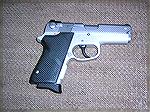 Standard S&W 3913 9mm with Hogue grips and Trijicon sights.
