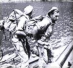 A two-man SAS demolition team load up ready for their mission with packs filled with high explosives, prior to a raid on German coastal gun batteries on a Greek island in 1944. Note the M1 Carbine.