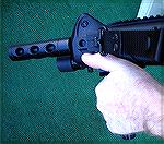 This demonstrates the most effective way to grip a vertical front grip on a rifle for competition shooting.  This enables both rapid transitions from target to target, but also much better accuracy wi