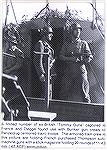 A couple of German soldiers with captured Thompson SMGs.