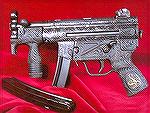 Heavily engraved machine pistol.