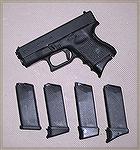 Glock 27 with different magazine floor plates. The magazine in the gun has a Pearce floor plate with a shelf for your pinky finger.

The mags below the gun are all Glock tubes with the following flo