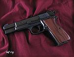FEG Hi-Power 9mm pistol. Kurt Wickman installed the larger 1911-size Novak Lo-mount sights front and rear and reblued the slide. Hogue Pau Ferro stock panels and Allen head stock screw.