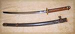 From Mike Wolf
This is an example of an Officers Wakazashi. A Wakazashi is considered a short to medium length sword carried as a companion to a Katana. This particular blade is hand made and signed 