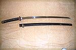 From Mike Wolf
This example is an officers Shin-Gunto. It has a hand made blade that is signed by Kanemici, which puts it around 1400-1500.