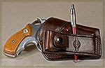 This Mitch Rosen "Workman" holster was designed by writer/shooter Dave Workman to let you tuck a shirt in over it. The shirt tucks into the gap where the ballpoint pen is. All that shows is the snap-o