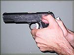 This is the classic Thumb-over-Thumb grip as espoused by Jeff Cooper, with the stronghand thumb riding the safety lock of the 1911 pistol.
Photo by Ron Avery