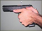 This is another variation of the modern Thumbs Forward grip where the offhand wrist is exaggeratedly cocked, putting the hand lower on the gun and the thumb further forward on the pistol.
Photo by Ro