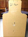 Full size humanoid cardboard target shot with a Remington Police 870 shotgun (18.5" IC barrel), using Federal 00 Buck at a distance of 21 feet.