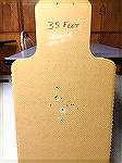 Full size humanoid cardboard target shot with a Remington Police 870 shotgun (18.5" IC barrel), using Federal 00 Buck at a distance of 35 feet.