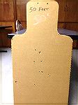 Full size humanoid cardboard target shot with a Remington Police 870 shotgun (18.5" IC barrel), using Federal 00 Buck at a distance of 50 feet.