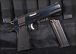 Colt 1911 in 9x23 with basic semi-beavertail grip safety, trigger with adjustable overtravel and Crimson Trace grips.