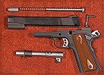 Colt's Lightweight Government Model fieldstripped. It includes a full length guide rod, trigger with adjustable overtravel, semi-beavertail grip safety, flat mainspring housing and this one has had th