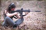 This young lady seems to be serious about shooting her Kel Tec SU-22 rifle.