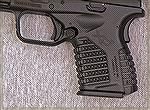 The forward lip on the XDS short magazine sticks out just enough for a shooter to grip it between the ring and pinky fingers.