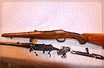 This is a take down Mannlicher-Schoenauer rifle (not carbine). Many like this were English conversions with a push pin up front and a small lever at the trigger guard.
They also has a folding peep si