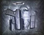 Here is a Glock 19 Gen 4 in a Kydex holster made by a now-defunct manufacturer called N-Tac. There is also a magazine holder with a spare mag. 
