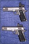 Two Colt "loaded" 80 series 1911s, a 9mm and a .45ACP, with Hogue grips and red dot sights.