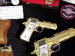 Gold Damascened Spanish handguns seen in a collection displayed in the NRA Collectors area at the 2019 NRA Annual Meetings & Trade Show. Visible are a Llama IIIa and part of a much larger IXa.