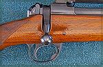 Weight saving areas include a scalloped-out receiver, drilled bolt handle, and no extra wood in the stock.